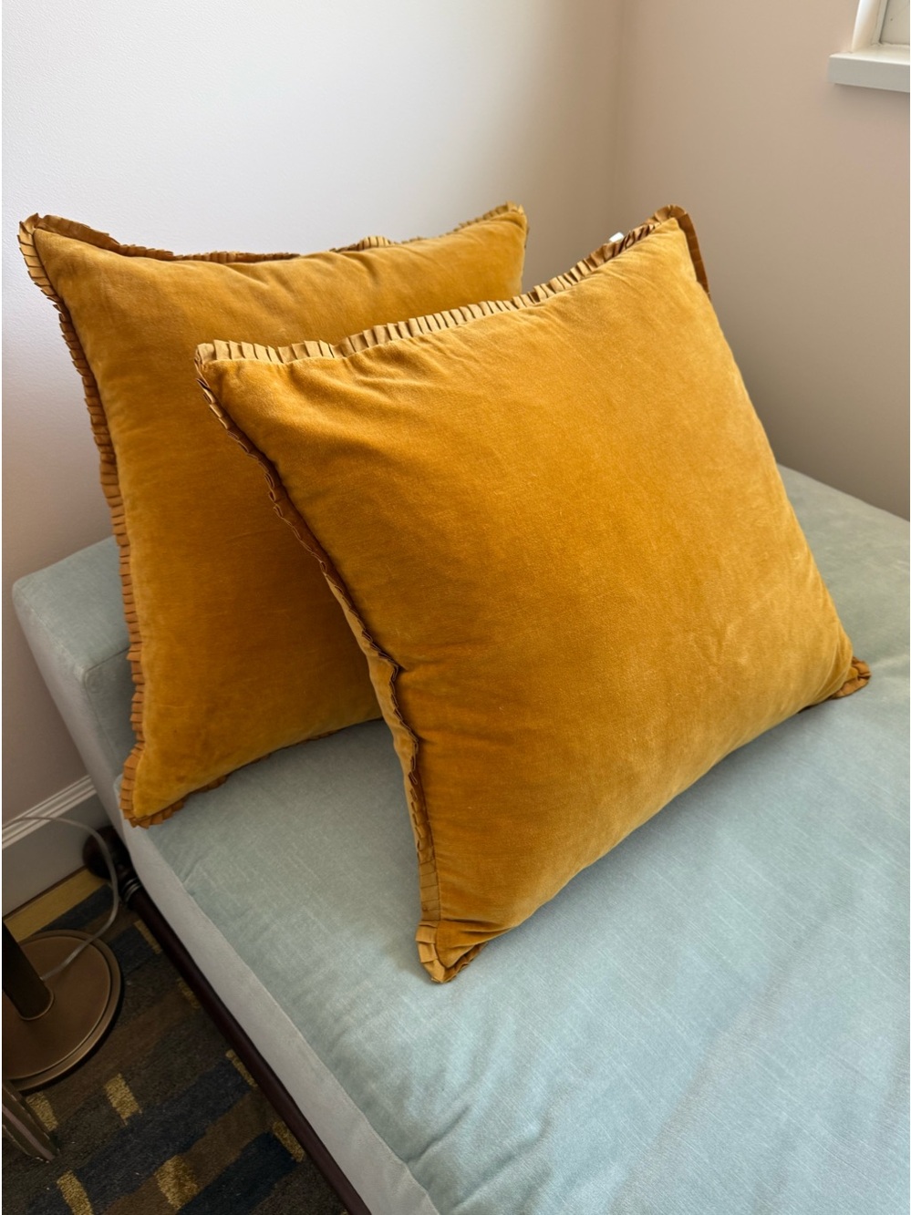 Two gold velvet pillows